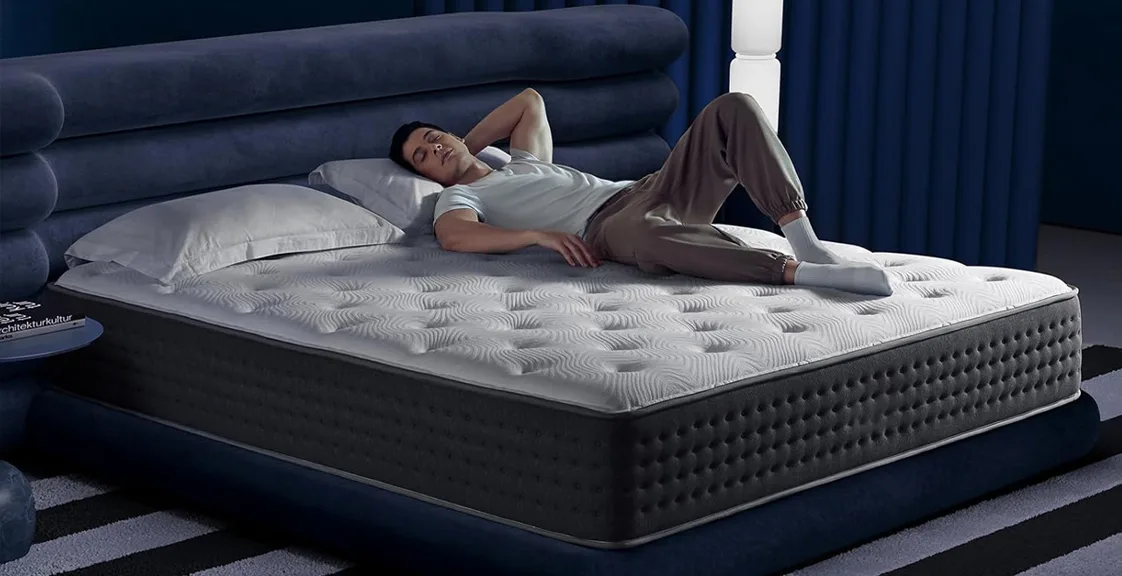 A man lying on a hybrid mattress resting