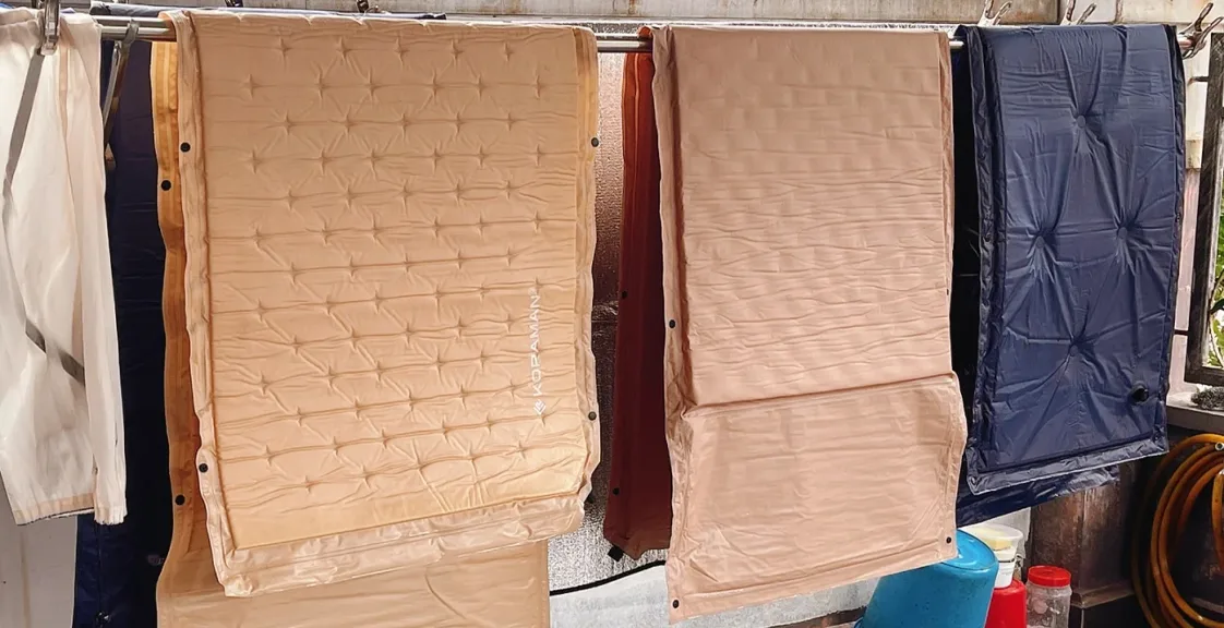 Air mattresses hanging to dry before folding and storage.