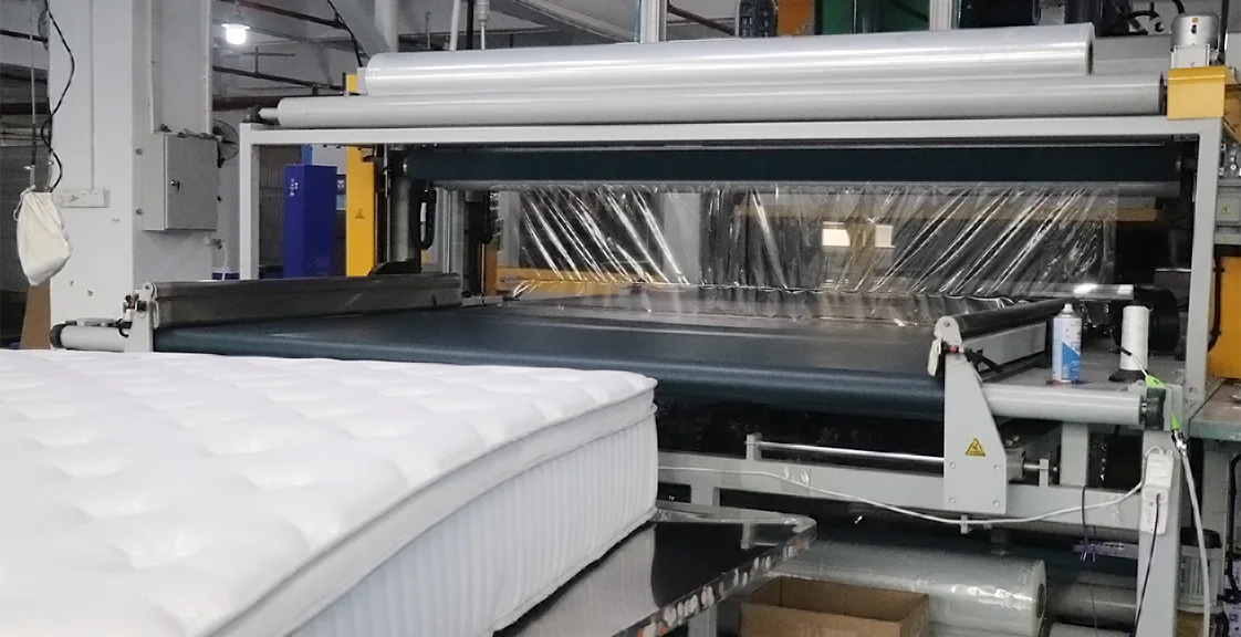 Automated mattress packaging machine in factory