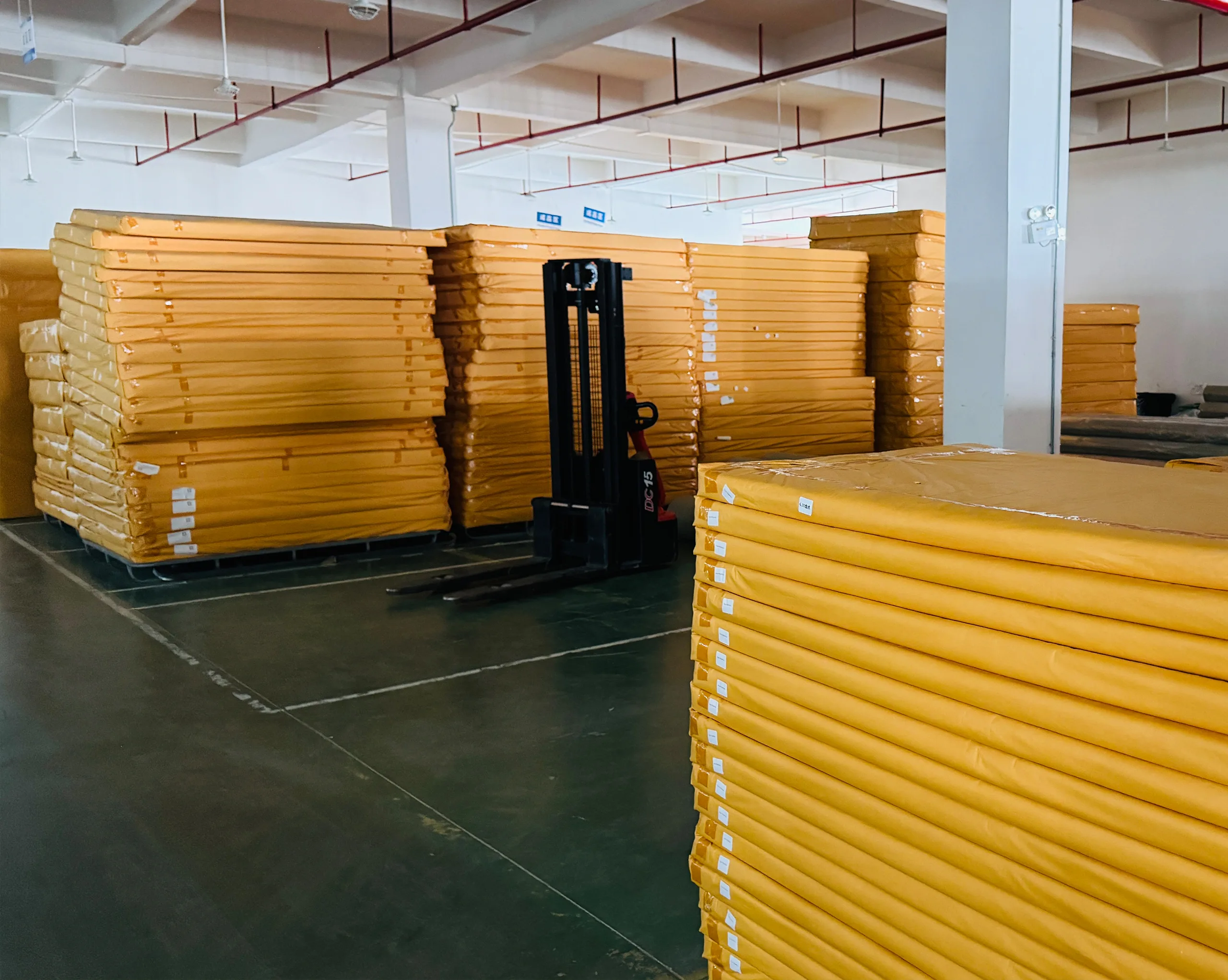 Packaged spring mattresses ready for shipment in the warehouse